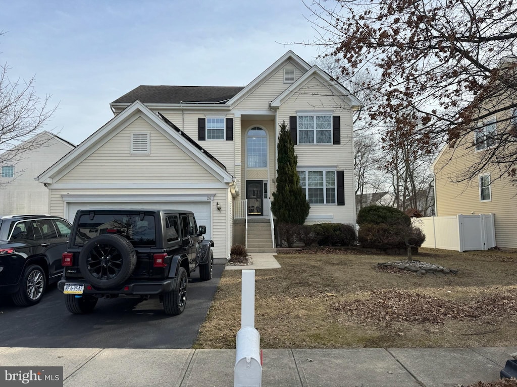 traditional home featuring driveway and an attached garage