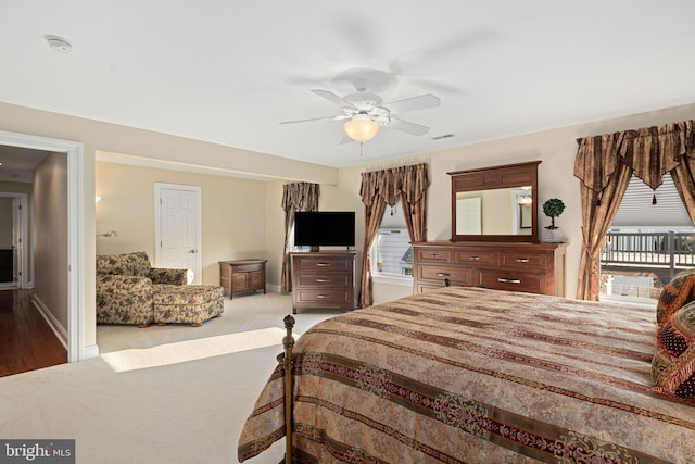 carpeted bedroom with baseboards, multiple windows, and visible vents