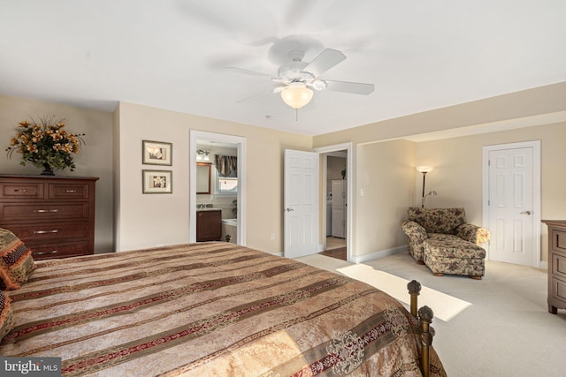 bedroom with light carpet, connected bathroom, baseboards, and ceiling fan