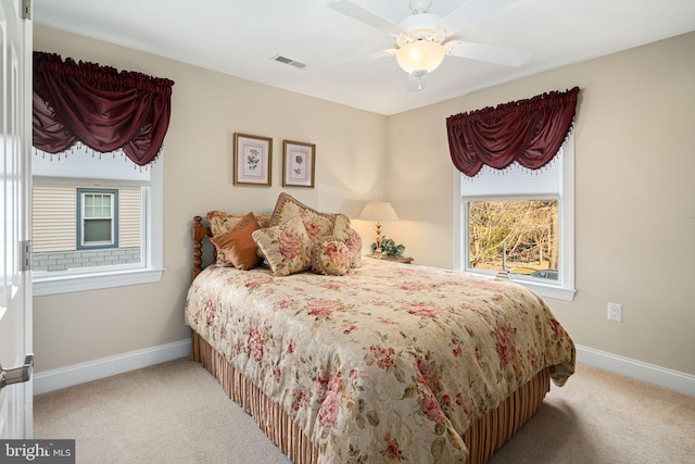 carpeted bedroom featuring visible vents, baseboards, and ceiling fan