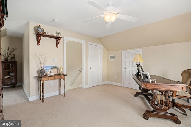 office area with visible vents, light carpet, vaulted ceiling, ceiling fan, and baseboards