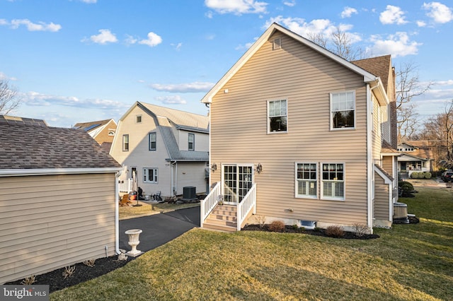 back of property with a yard and cooling unit