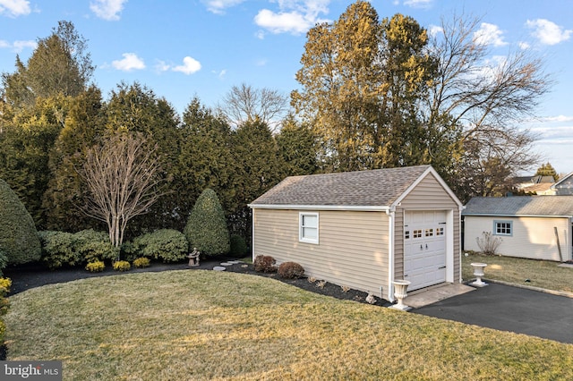 detached garage featuring driveway