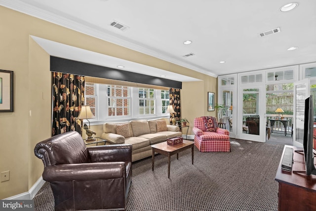 living room with ornamental molding, visible vents, carpet floors, and baseboards