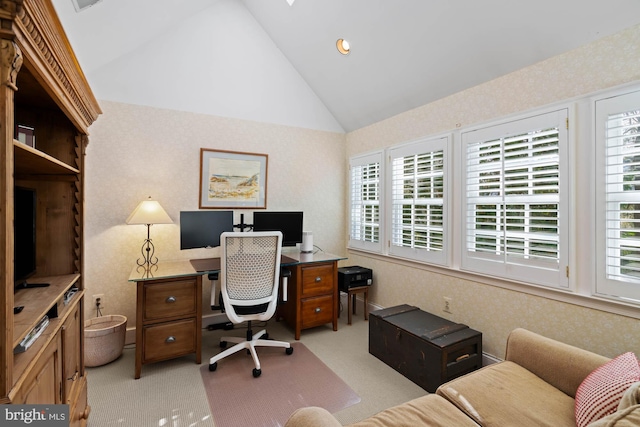 office space featuring high vaulted ceiling, wallpapered walls, and light colored carpet