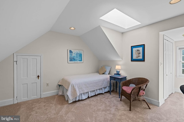 bedroom featuring vaulted ceiling with skylight, carpet, baseboards, and recessed lighting