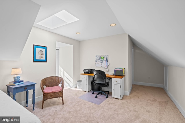 office space featuring lofted ceiling with skylight, recessed lighting, light carpet, and baseboards