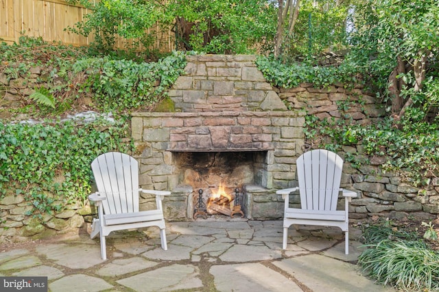 view of patio featuring an outdoor stone fireplace