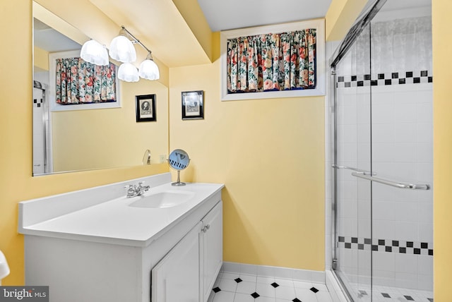 full bath with a shower stall, baseboards, and vanity