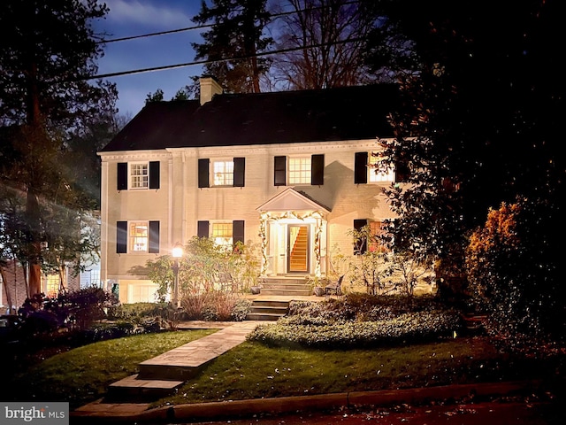 view of front of home featuring a chimney