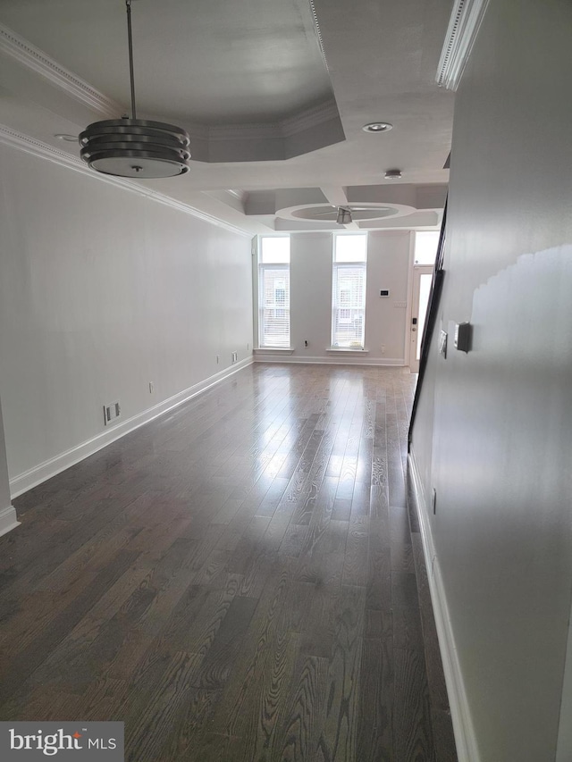 spare room featuring visible vents, ornamental molding, dark wood finished floors, and baseboards