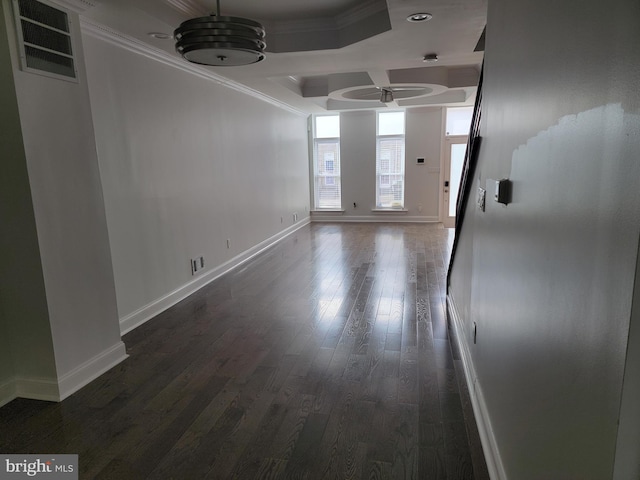 unfurnished room featuring dark wood finished floors, visible vents, crown molding, and baseboards