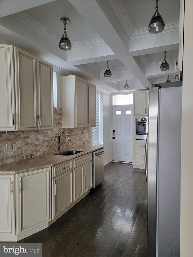 kitchen featuring dark wood-style flooring, stainless steel appliances, tasteful backsplash, ornamental molding, and a sink