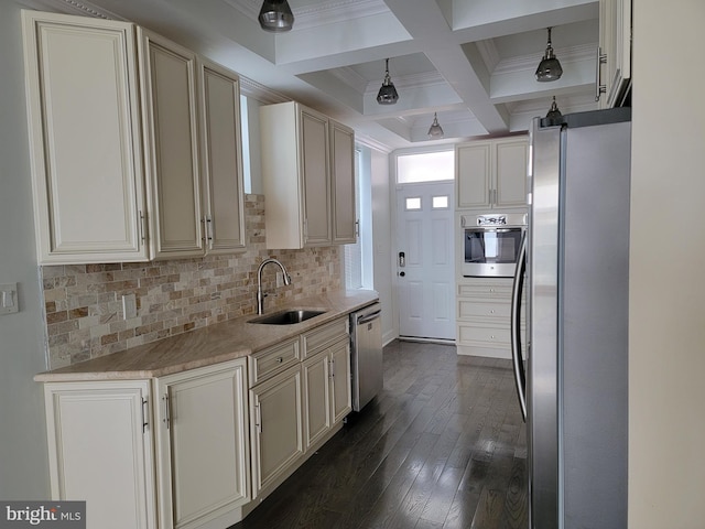 kitchen featuring backsplash, appliances with stainless steel finishes, a sink, coffered ceiling, and beamed ceiling