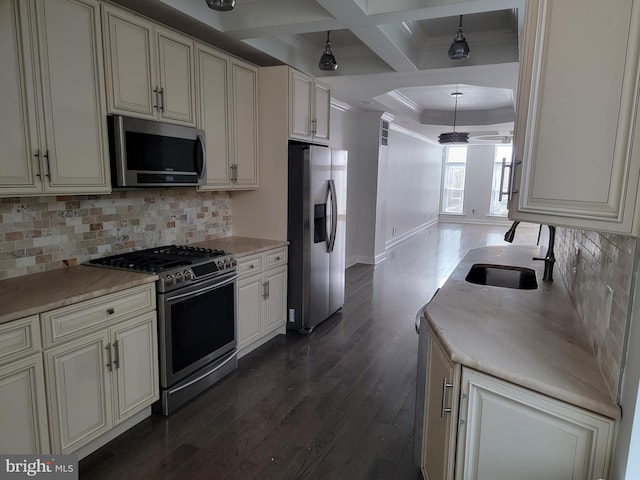 kitchen with stainless steel appliances, a sink, decorative backsplash, dark wood finished floors, and crown molding