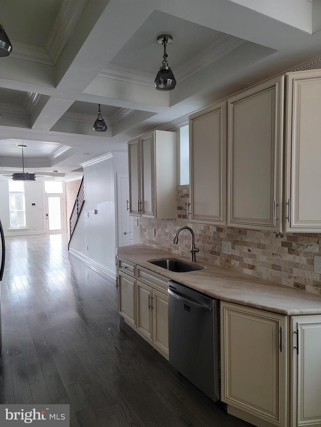 kitchen featuring cream cabinets, stainless steel dishwasher, ornamental molding, dark wood-type flooring, and a sink