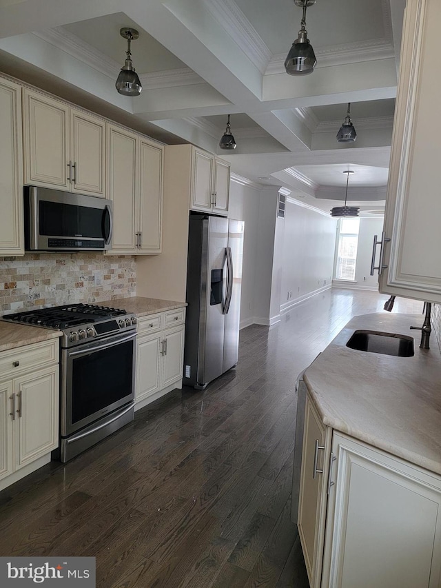 kitchen featuring ornamental molding, dark wood-style flooring, a sink, stainless steel appliances, and backsplash