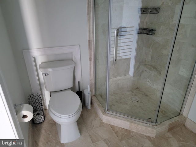 bathroom with a stall shower and toilet