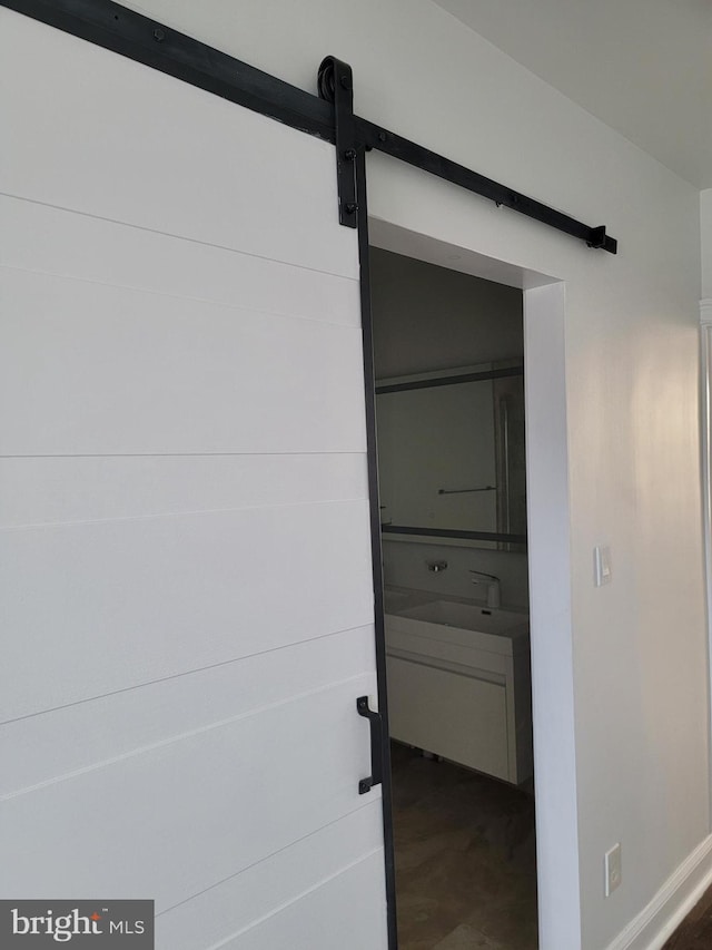 interior space featuring concrete flooring and a barn door