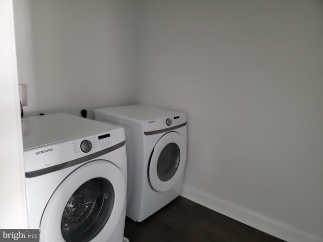 washroom with laundry area, independent washer and dryer, and baseboards