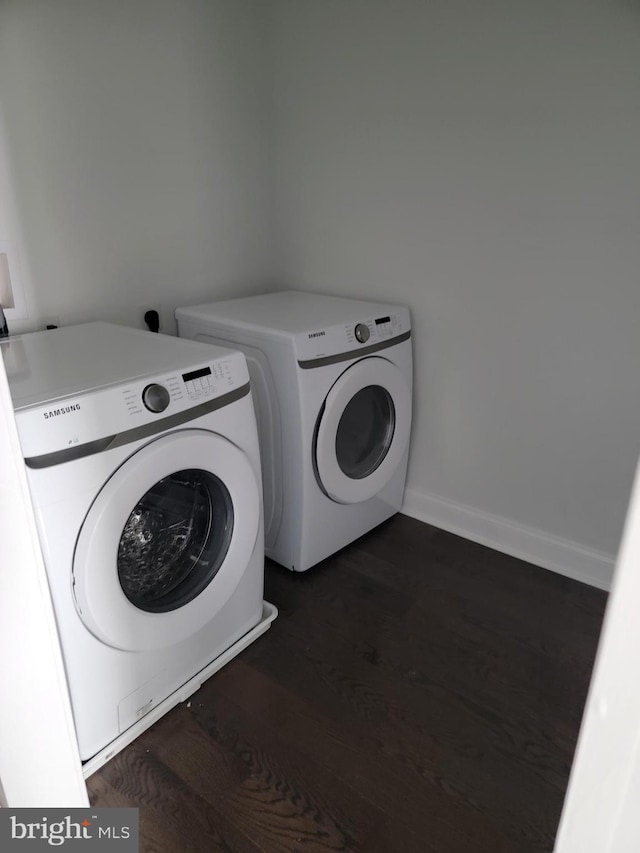 laundry area featuring laundry area, baseboards, dark wood-style floors, and separate washer and dryer