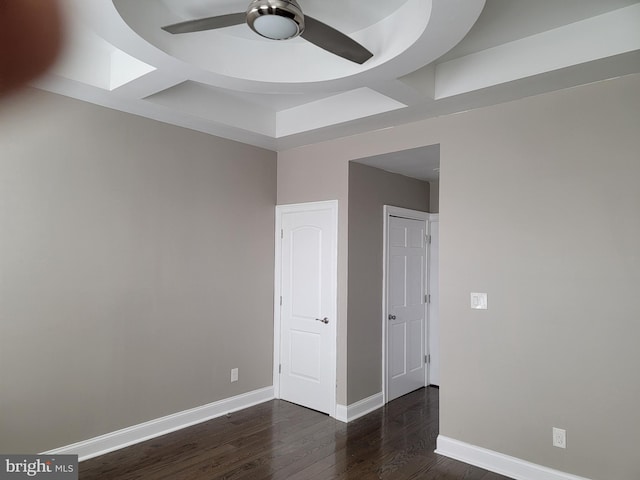 interior space featuring coffered ceiling, wood finished floors, a ceiling fan, and baseboards