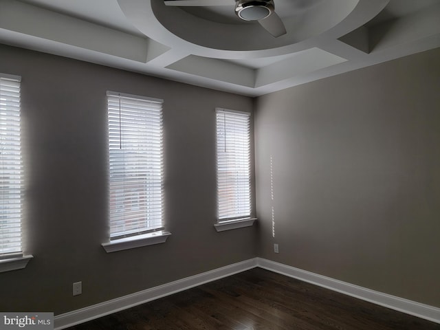 empty room with ceiling fan, dark wood-type flooring, and baseboards