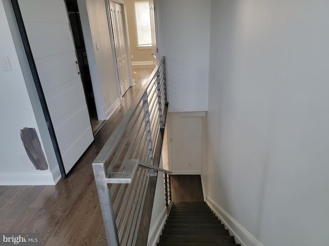 stairs with wood finished floors and baseboards