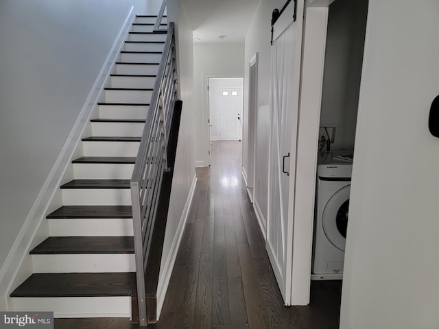 stairs featuring washer / dryer, wood-type flooring, baseboards, and a barn door