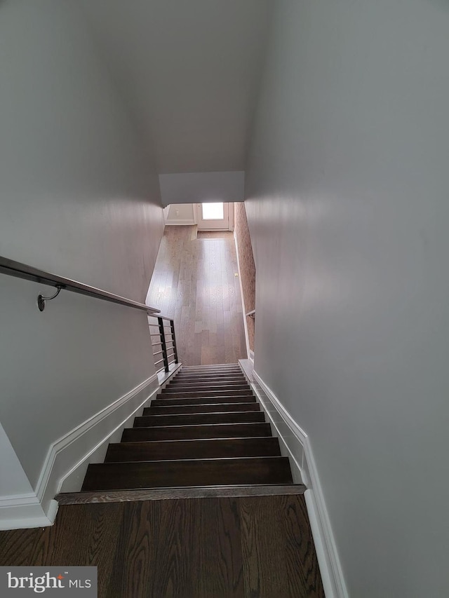 staircase with wood finished floors