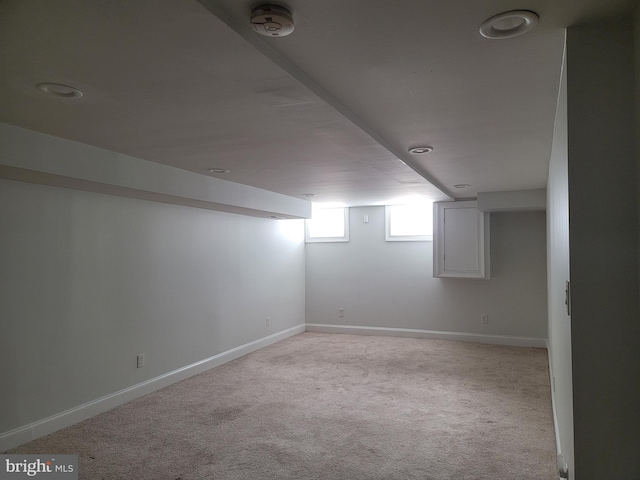 basement with baseboards and carpet flooring