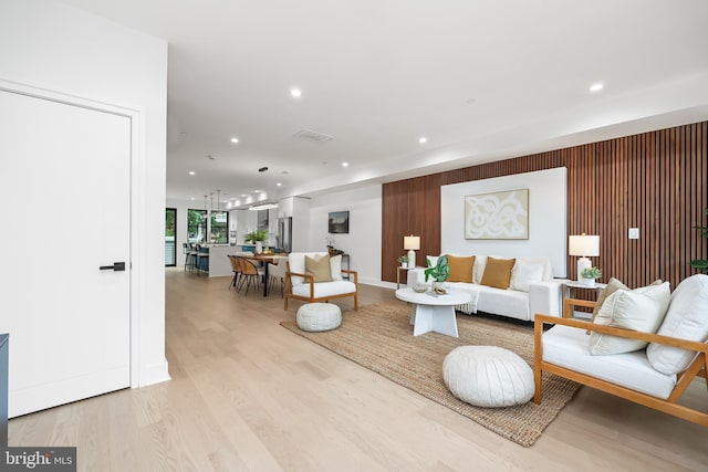 living area featuring light wood-type flooring and recessed lighting