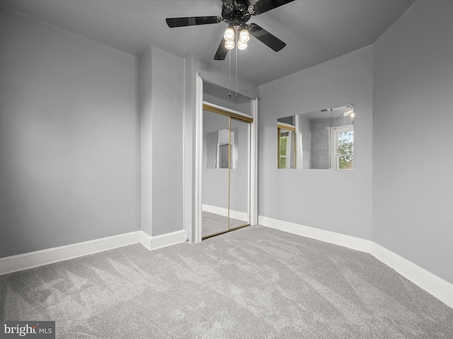 unfurnished bedroom featuring a ceiling fan, carpet, baseboards, and a closet