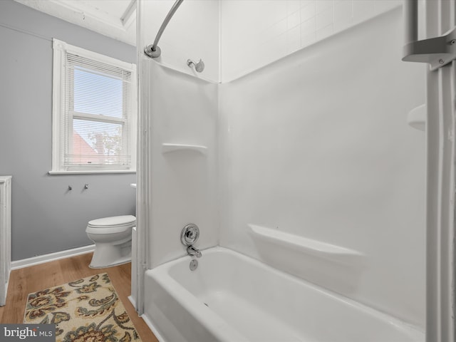 bathroom featuring shower / tub combination, toilet, and wood finished floors