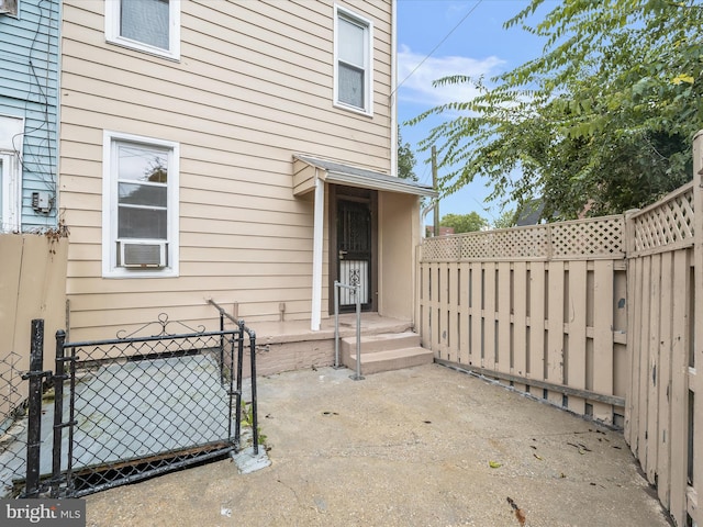 doorway to property featuring a gate, a patio area, and fence