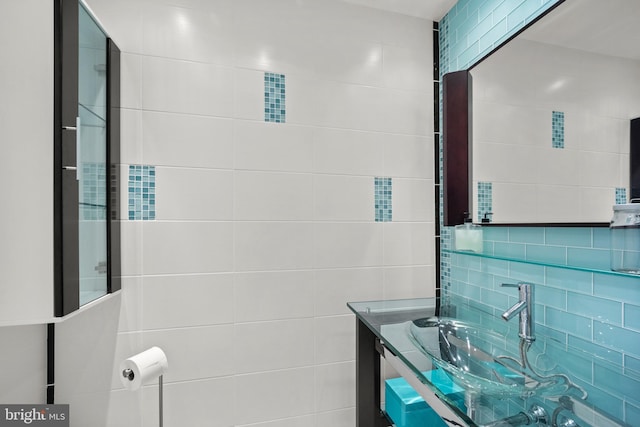 bathroom featuring tile walls and vanity