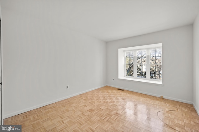 empty room with baseboards and visible vents