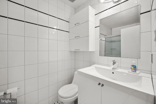 full bath with tile walls, tasteful backsplash, toilet, a shower stall, and vanity