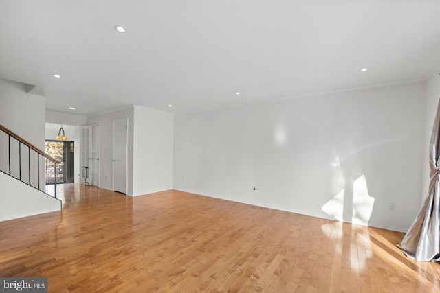 unfurnished living room with stairway, light wood-type flooring, and recessed lighting