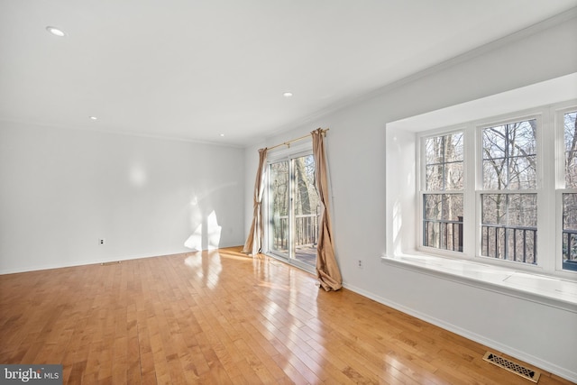 interior space featuring baseboards, visible vents, crown molding, light wood-style floors, and recessed lighting