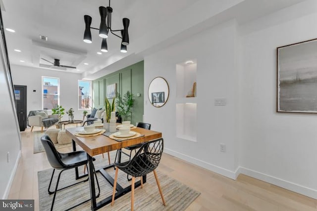 dining room featuring light wood-type flooring, baseboards, and recessed lighting