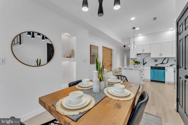 dining room featuring visible vents, baseboards, light wood-style flooring, a chandelier, and recessed lighting