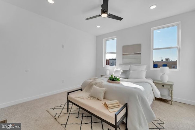 bedroom with baseboards, recessed lighting, a ceiling fan, and light colored carpet