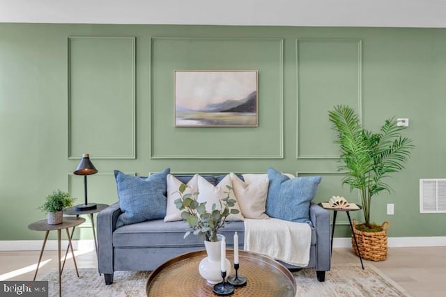 interior space with baseboards, visible vents, and wood finished floors