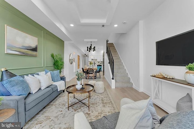 living area with stairs, baseboards, wood finished floors, and recessed lighting