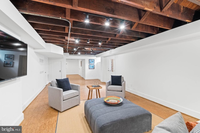 interior space featuring track lighting and baseboards