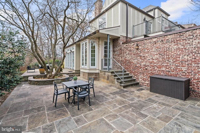 view of patio / terrace featuring outdoor dining space and a balcony