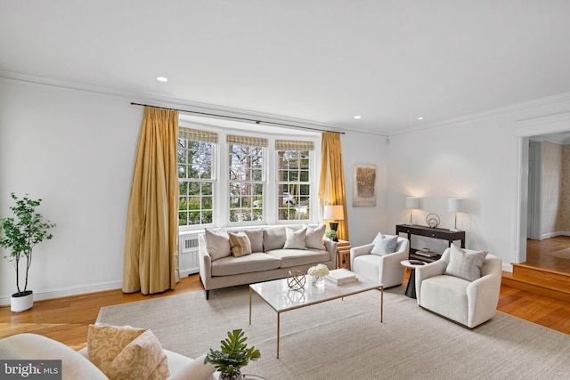 living room with baseboards, ornamental molding, wood finished floors, and recessed lighting