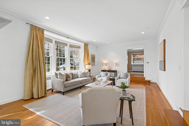 living room featuring recessed lighting, radiator, light wood-style flooring, ornamental molding, and baseboards