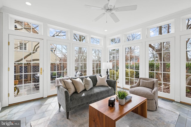 sunroom with visible vents, a wealth of natural light, and a ceiling fan